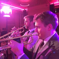 Function band trumpeters performing at a charity ball in London