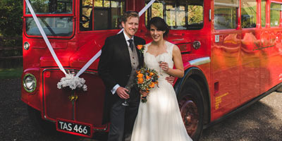 Bride and groom with London Routemaster bus