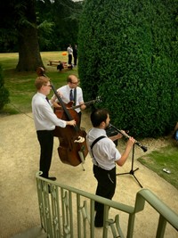 Acoustic jazz trio performing live roaming walkabout music for a wedding reception in Gloucestershire 