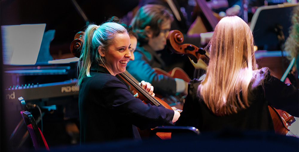 Cellist Katt Newlon performing with the Down for the Count Orchestra